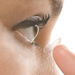 a lady putting contact lenses in
