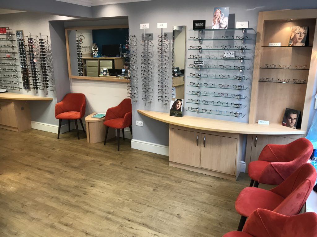 Reynolds & Slater Opticians reception area with optical displays and red seats