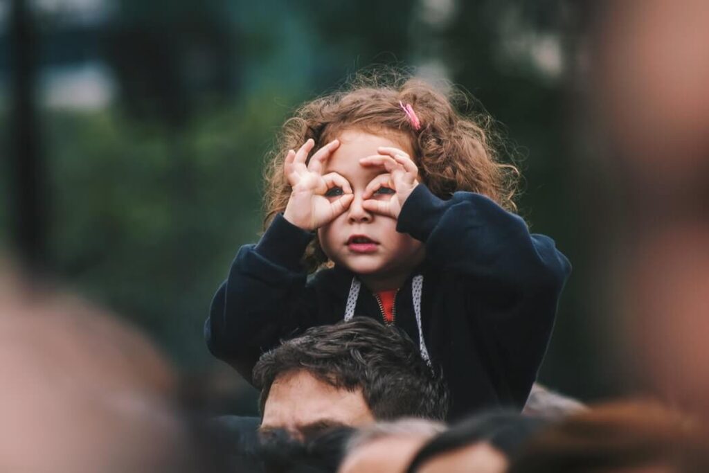 Child holding her hands over her eyes like spectacles