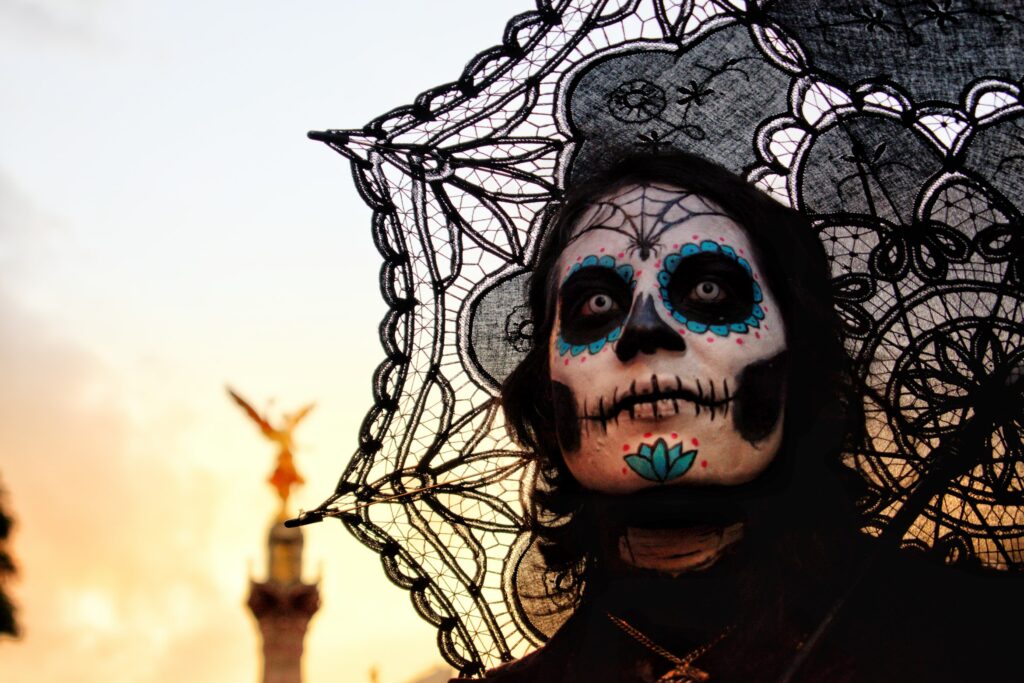 Person dressed in day of the dead costume with white contact lenses