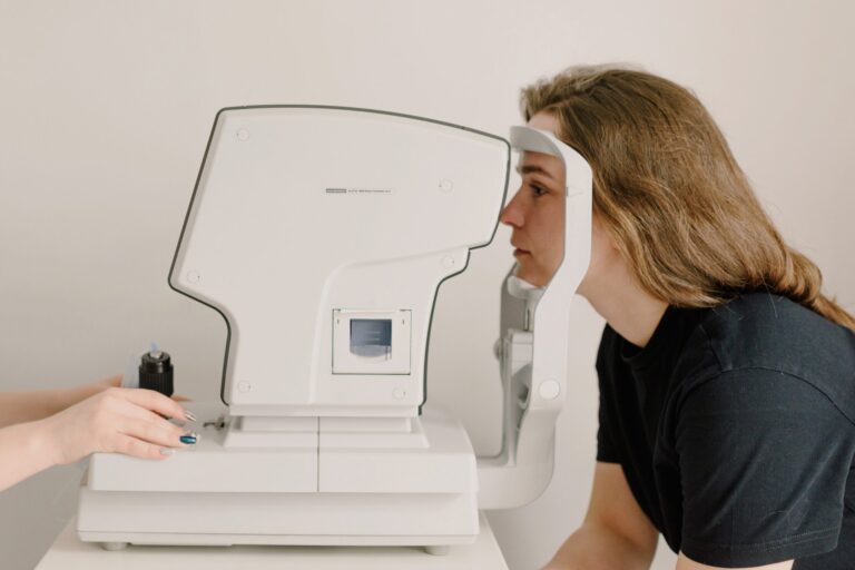 Female patient leaning into eye test machine