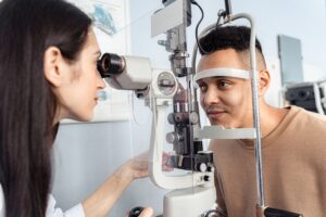 optician assessing patients eyes using optical machinery